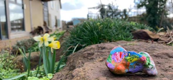 Coloured painted rock in nature