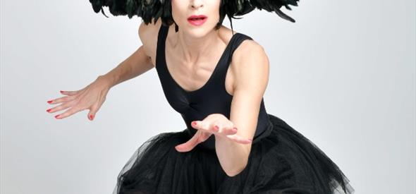Image of lady wearing a black feather costume , jumping