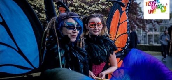 two ladies dressed up as giant butterflies