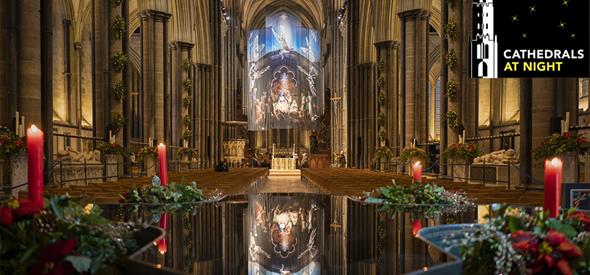 Inside Cathedral with candles, festive flowers and reflections