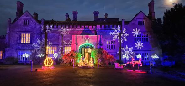 Colourful light decorations on a house with winter snow flake projections