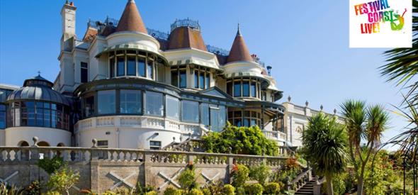 The Russell-Cotes Victorian Villa with blue sky in the background and green lawn in the foreground