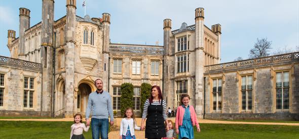 Family walking hand in hand outside of Castle