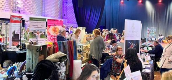 Image of previous festival with multiple booths set up and people milling about