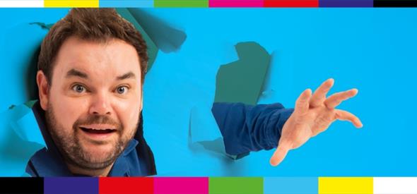 Image of man jumping through a blue wall