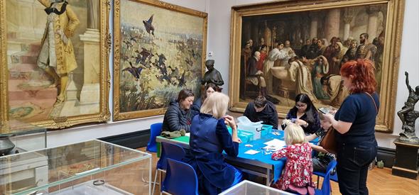 Families doing crafts in an art gallery