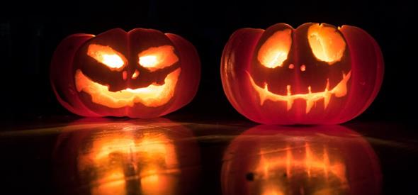 Two scary looking pumpkins that glow in the dark