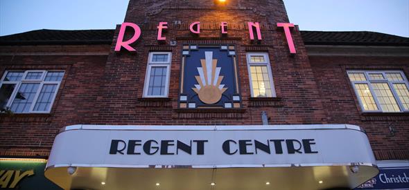 Front of the Regent Centre Building lit up at night time