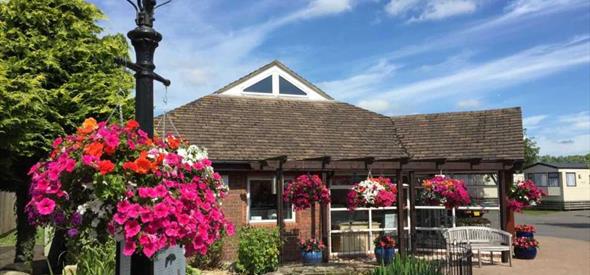 reception on a beautiful bright day with flowering hanging baskets