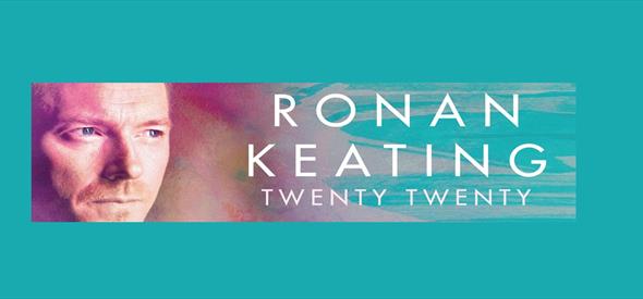 Ronan Keating headshot with blue and purple pastel background.