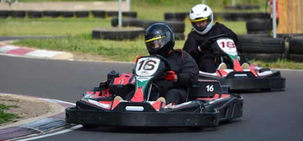 Two people raceing each other in go karts