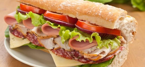 Sub style sandwich filled with meats and veg