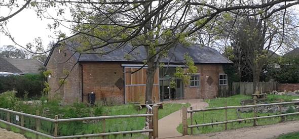 photo of Kingfisher Barn Visitor Centre with trees and garden
