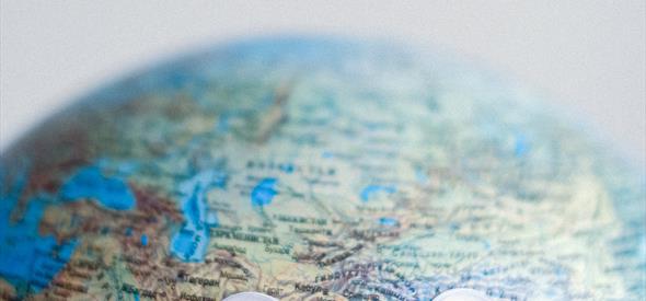 A colourful globe with googly eyes