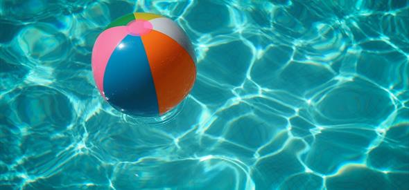 Inflatable ball floating in clear water.
