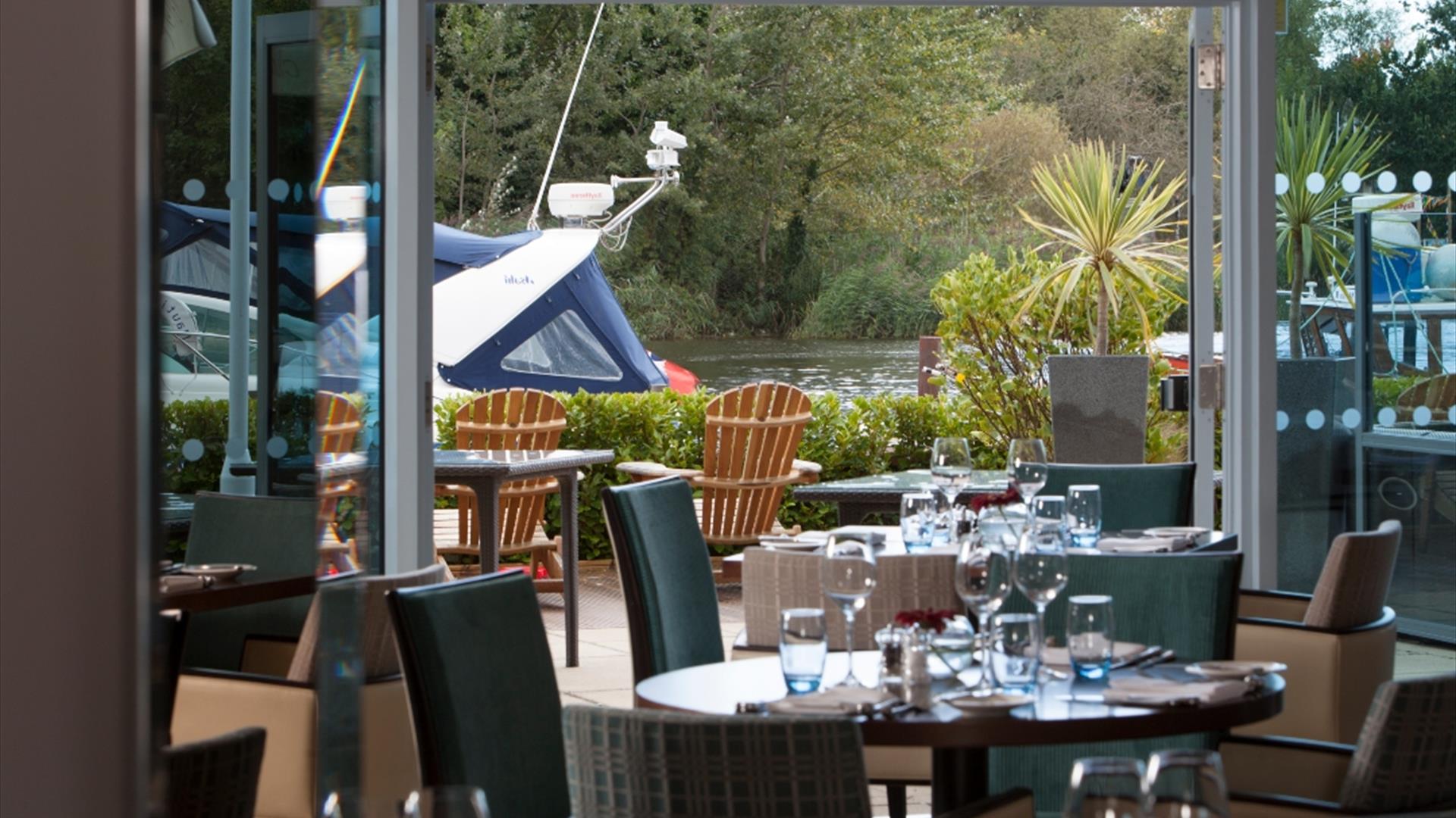 Inside the Captains club hotel restaurant with tables set up for dinner service