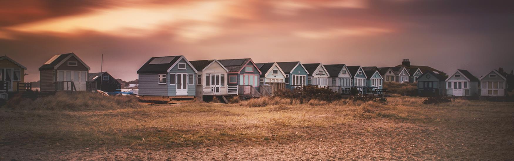 Orange sunset glow arround the mudeford beach huts in christchurch