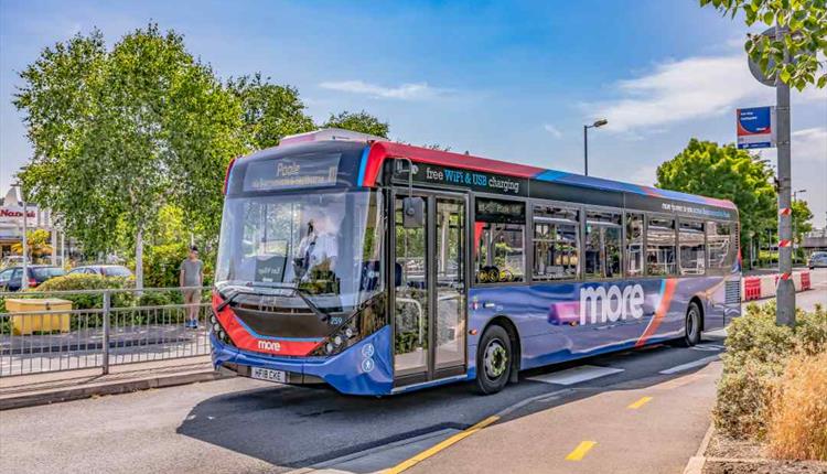 The bus driving off from the stop