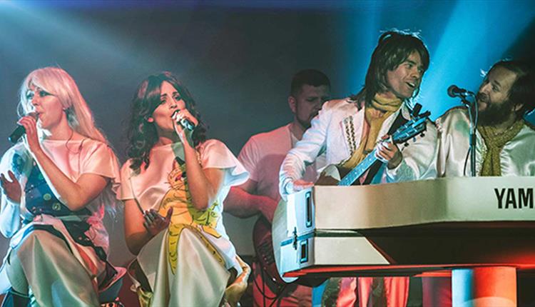 Abba tribute band on stage performing