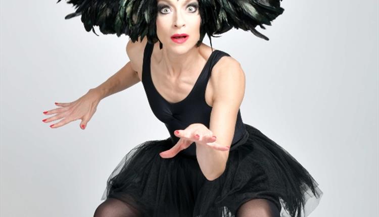 Image of lady wearing a black feather costume , jumping