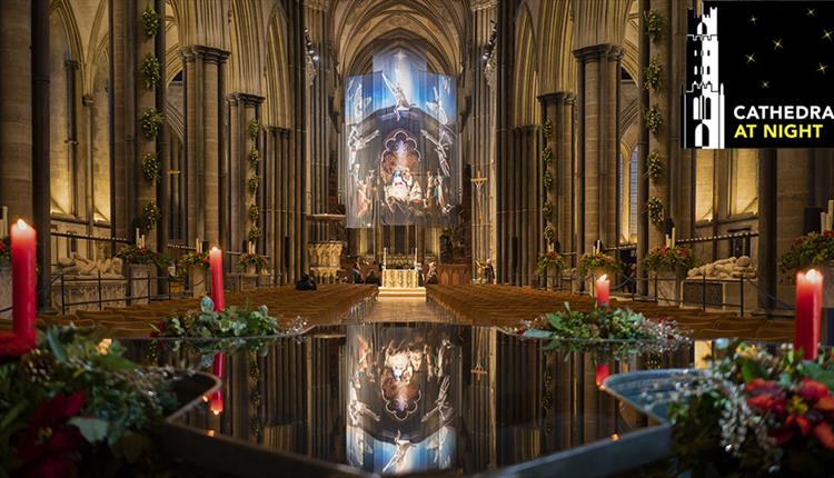 Inside Cathedral with candles, festive flowers and reflections