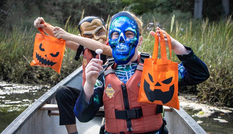 Children enjoying a Halloween Candy Canoe Hunt