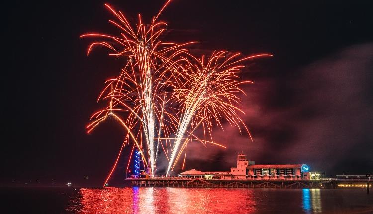 Image of a red firework going off over Bournemouth Pier