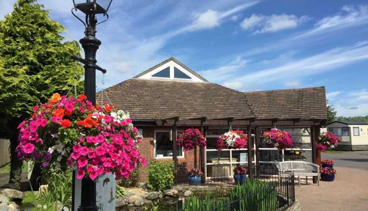 reception on a beautiful bright day with flowering hanging baskets