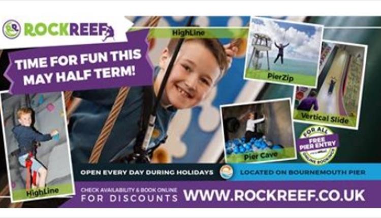 boy smiling at camera on a climbing wall