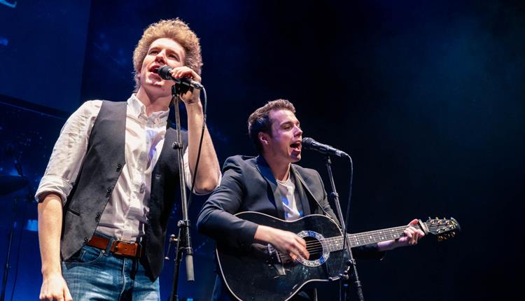 Two men tribute band singing on stage