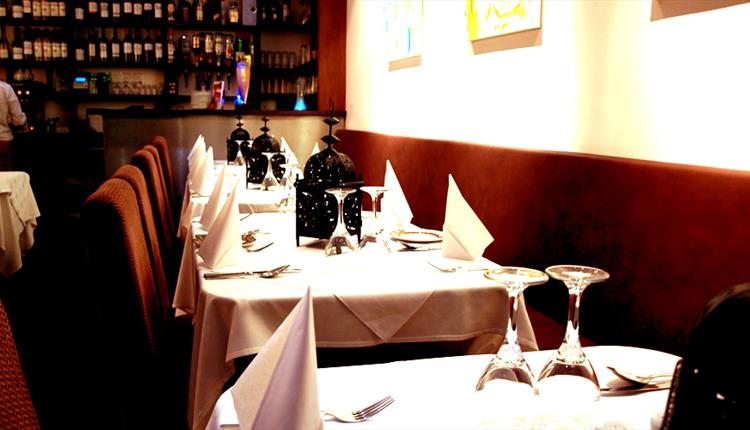 inside of restaurant laid out for dining.