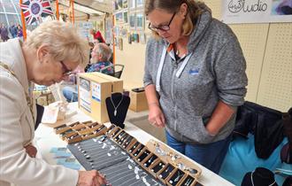 Woman looking at jewelery pop up store