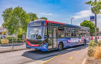 The bus driving off from the stop