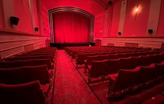 Inside the screen room with red deco red carpet and red seating