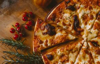 cheesy pizza on wooden table top