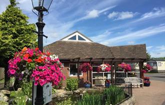 reception on a beautiful bright day with flowering hanging baskets