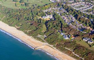 Arial view of Highcliffe beach with the castle sat in the background
