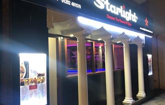outside of the restaurant lit up at night.