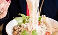 Lady eating noodles