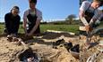 people working on some bronze forging