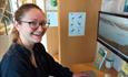Lady pressing button to operate interactive screen