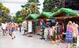 Market stalls and palm trees
