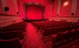 Inside the screen room with red deco red carpet and red seating