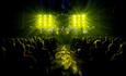 Band performing to a captive audience with amazing lights on stage at the bic
