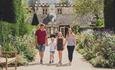 Family holding hands walking on a path at Beaulieu