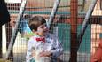 Kid holding a guinea pig and smiling