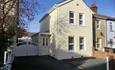 Exterior house with parking space on a bright sunny day