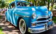 Vintage blue car with crowd behind it