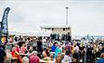 Crowds at Seafood Festival on Poole Quay watching live music.