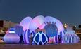 The airship Orchestra illuminates the Bournemouth night sky with visitors interacting with it